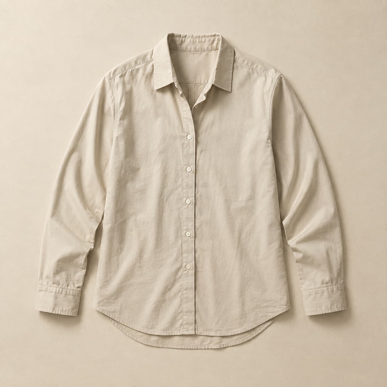 Pale sand button-through shirt laid flat with the collar open.