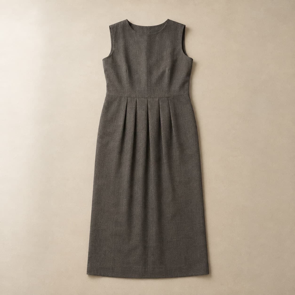 Dark grey column dress with four front pleats laid flat.