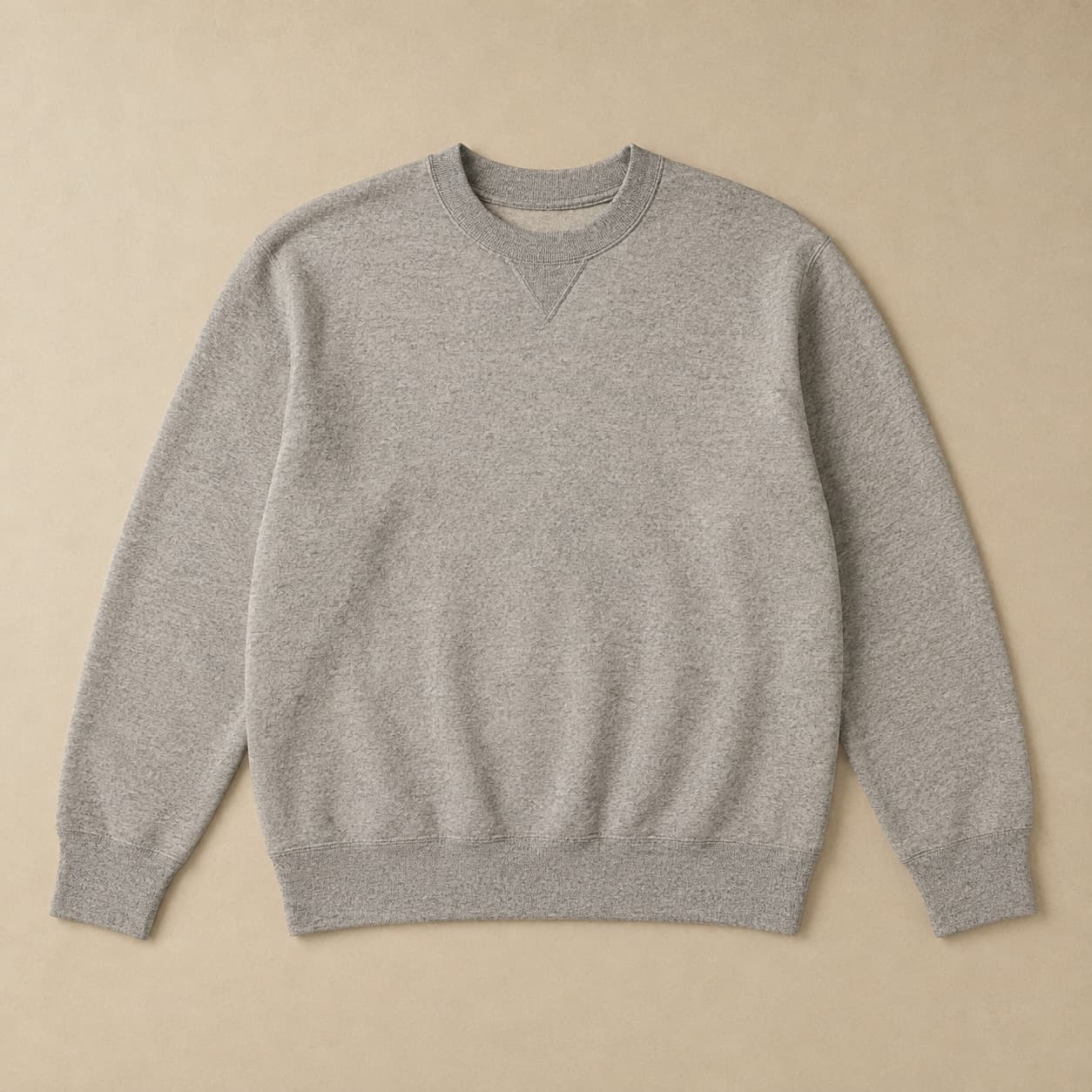 Grey crew-neck sweatshirt with a V insert at the collar laid flat.