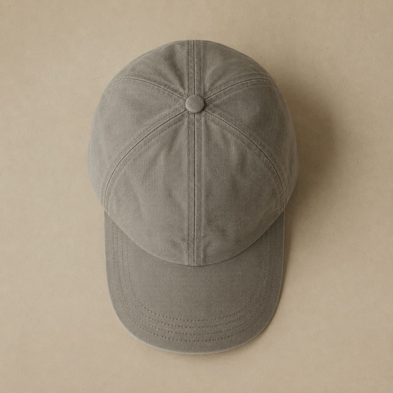 Grey six-panel cap photographed from the side against a pale background.