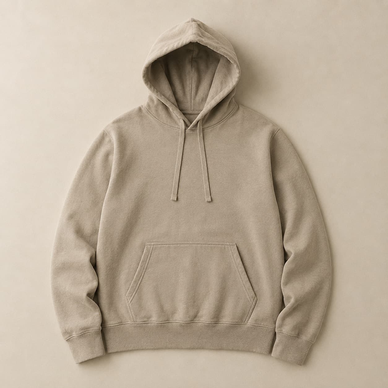 Sand-coloured hooded sweatshirt laid flat with the hood spread.