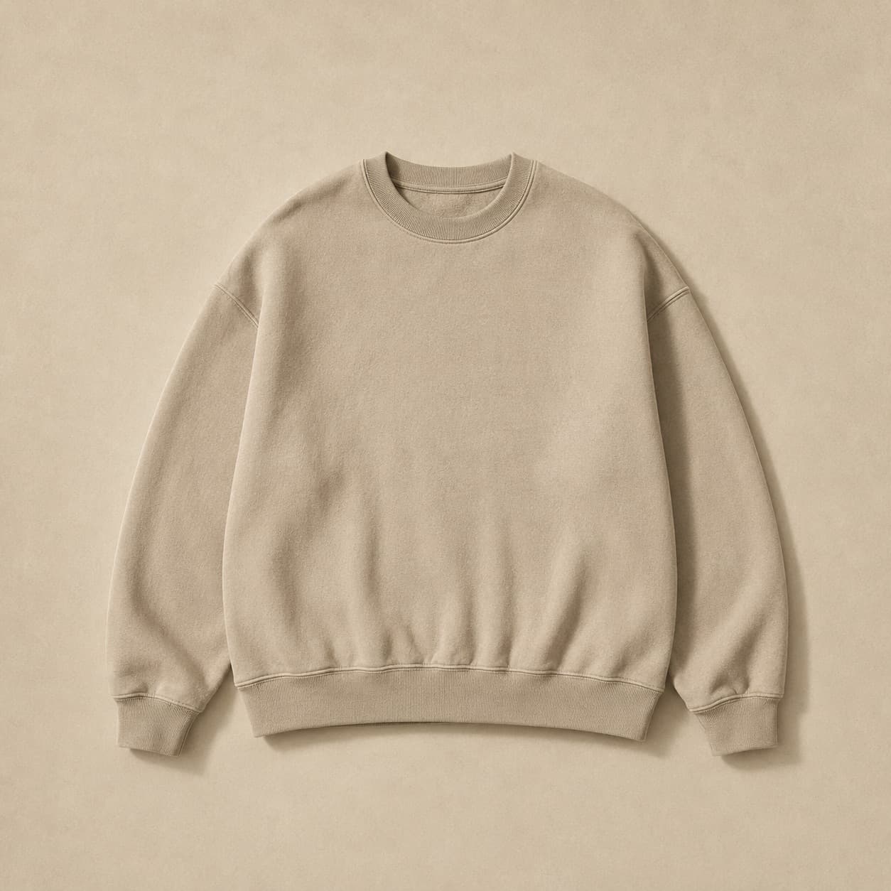 Sand-coloured crew-neck sweatshirt laid flat.