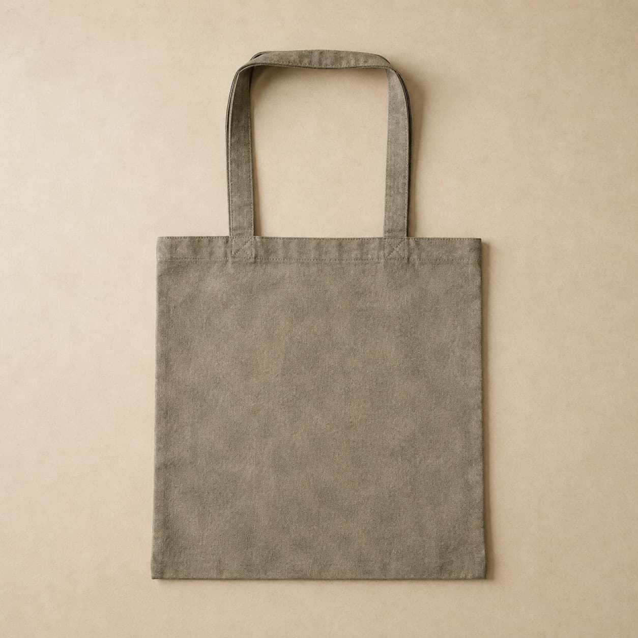 Flat mottled grey canvas tote bag with two straight handles.