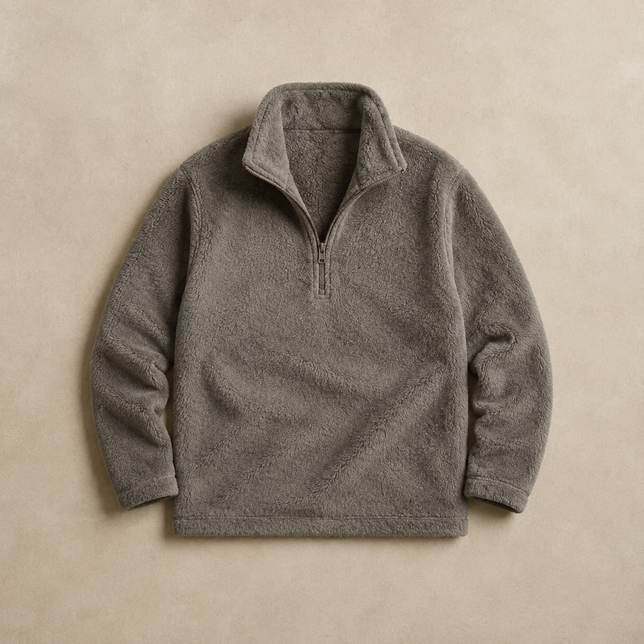 Grey quarter-zip fleece laid flat with the zip half open.