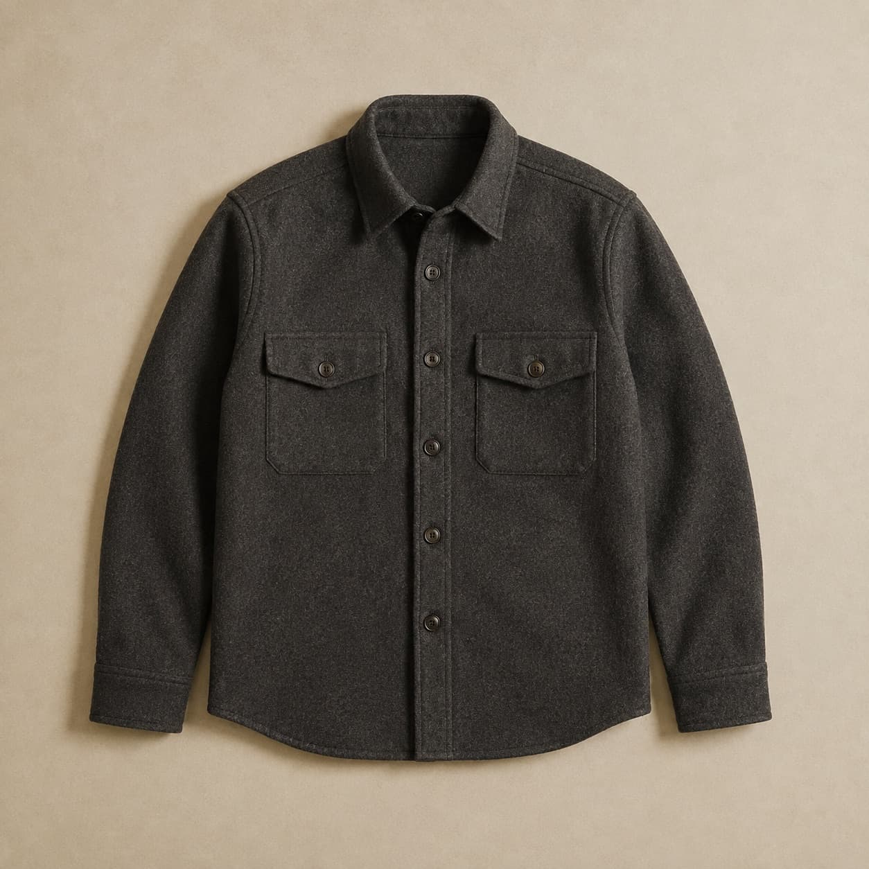 Charcoal wool overshirt with two flapped chest pockets laid flat.