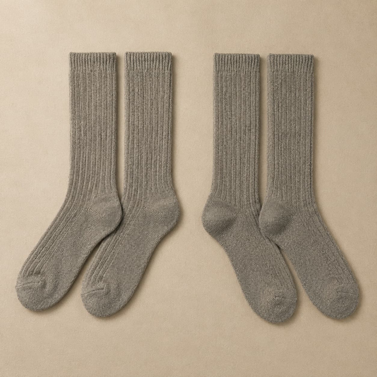 Two pairs of grey mid-calf wool socks laid flat side by side.