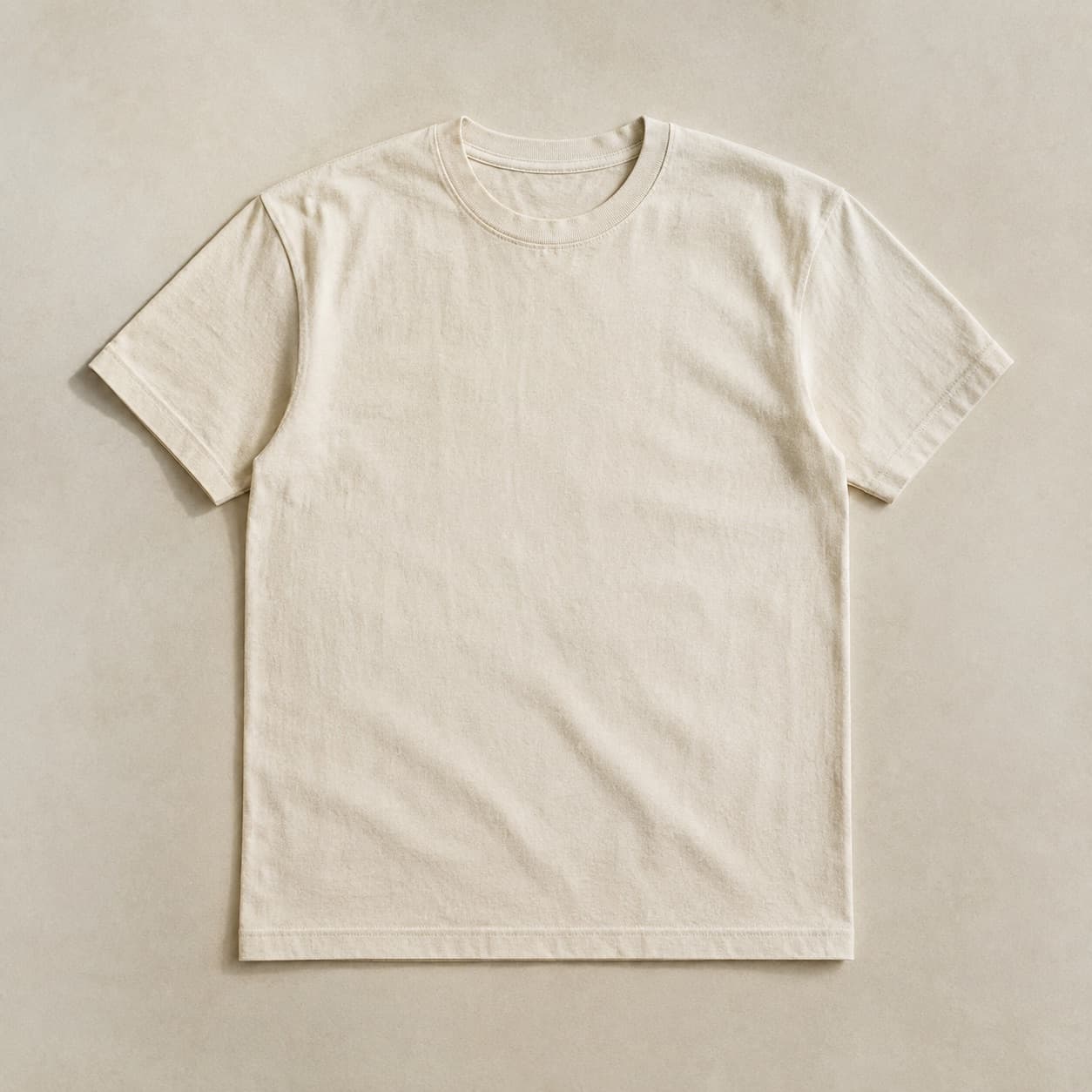 Undyed cream tee with a faintly uneven tone laid flat.